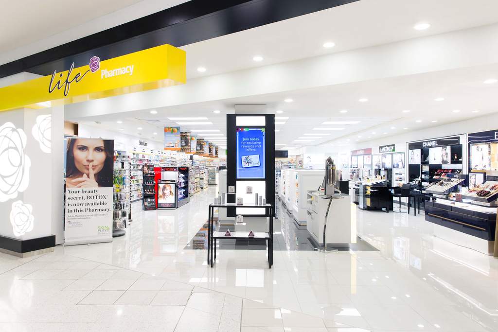 The shop floor at Life Pharmacy St Lukes, looking down the main aisle